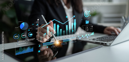 Quadro su tela Professional business analysis with modern digital graphs and charts displayed on a tablet, showcasing financial trends and data insights in a corporate environment Haptic