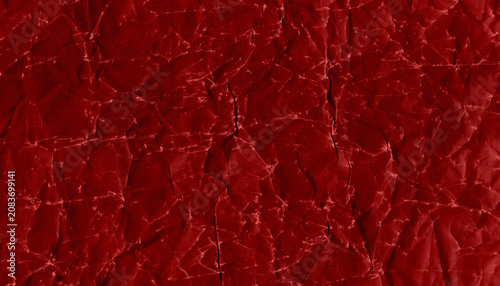 Картината върху платно Dark red crumpled paper texture with pronounced wrinkles, folds and irregular lines