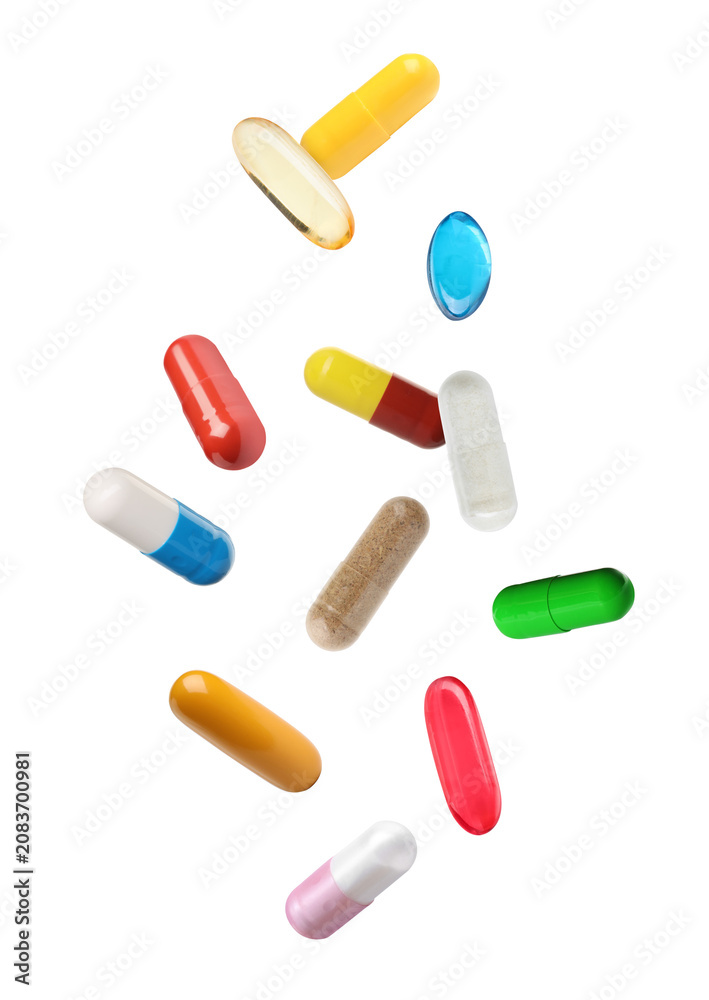 Fototapeta premium Many various pills falling against transparent background