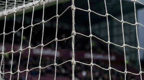 Soccer goal net close up stadium view with blurred background