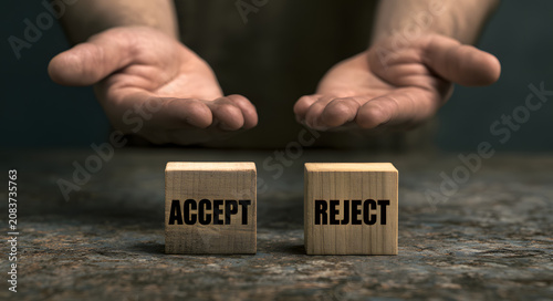 The concept of decision making shown with hands positioned above blocks labeled ACCEPT and REJECT
