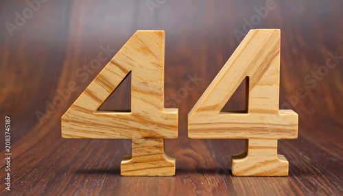 Wooden Number 44 on a Dark Wooden Surface.