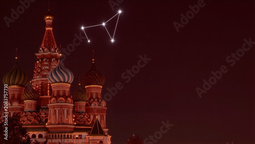 Illuminated St. Basil's Cathedral under a starry night sky, glowing domes against deep red heavens.