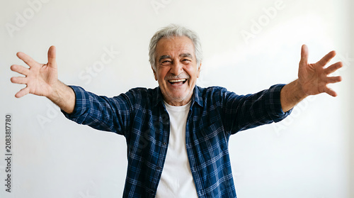Happy senior man with open arms