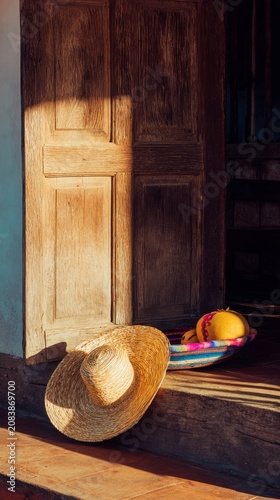 Sombrero vueltiao and bandeja paisa on stone doorstep, Colombian heritage concept.

