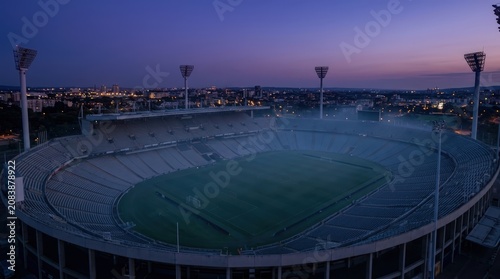 High angle drone shot of an empty soccer stadium during dusk