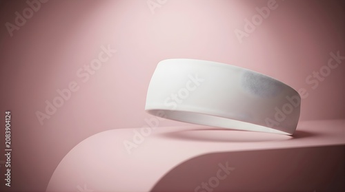 White fitness headband with circular patterned texture on soft pink studio background for sports activewear product display