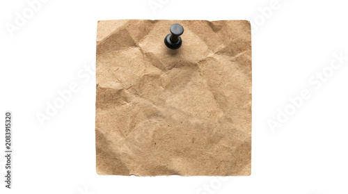 Brown crumpled paper pinned with thumbtack.