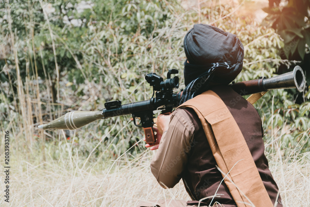 Fototapeta premium Outdoor military concept. Person armed soldier weapon rocket launcher shoulder aim outdoor field camouflage combat military attack defense war conflict