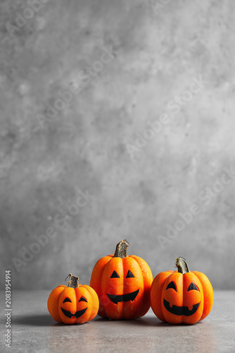 Smiling pumpkins displayed on a simple background during the Halloween season