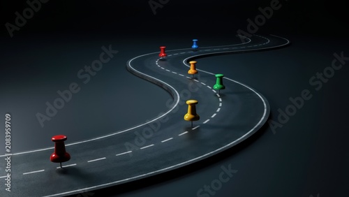 Winding dark asphalt road with colorful pushpins marking a journey or business strategy pathway.