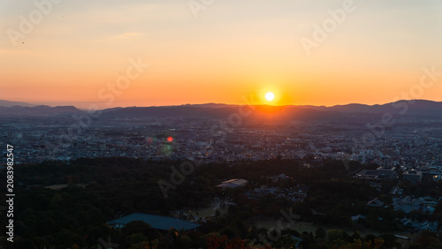 Obraz na płótnie Cityscape with Sunset and Mountains