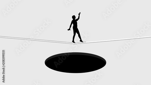 Silhouette of a person walking on a tightrope above a dark circular hole 