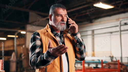 Photography Carpentry, conflict and phone call with man in warehouse for management or problem solving