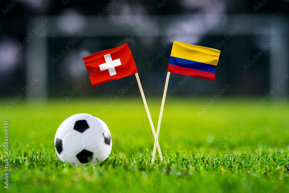 Obraz premium Switzerland vs Colombia, Round of 16, national flags before international football match, football on green grass with stadium in the background, BC Place, Vancouver, Canada, July 7, 2026