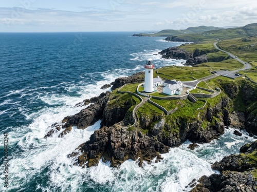 White lighthouse on a rocky coastline during daytime with crashing waves and green hills