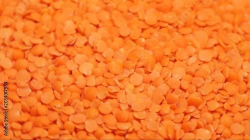 Rotation of red lentils close-up. Top side view