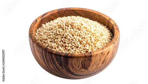 A wooden bowl filled with toasted sesame seeds on a black background.