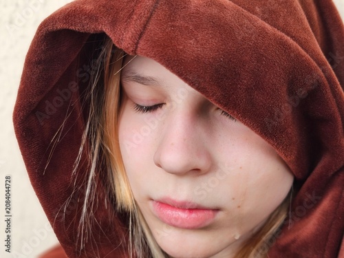 A teenage girl with depression and a withdrawn posture. Understanding problems and loneliness in children
