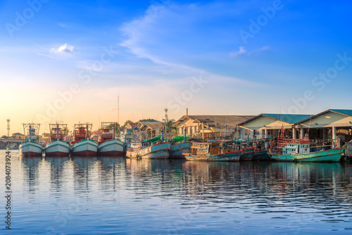 Colorful Fishing Boats Moored at Peaceful Harbor During Sunset