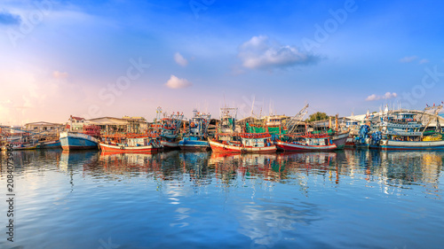 Colorful Wooden Fishing Boats Moored in Calm Harbor Waters
