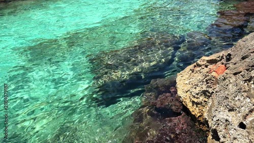 Crystal clear turquoise sea water and scenic rocky coast with sailing boats under a blue sky. summer vacation concept.