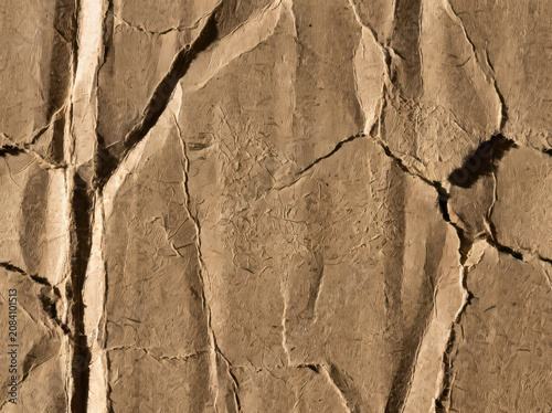 Crumpled and cracked brown paper texture with deep creases and rough surface detail.