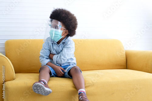 African boy wears a face mask for hygiene purposes. Prevention of respiratory infectious diseases in children.