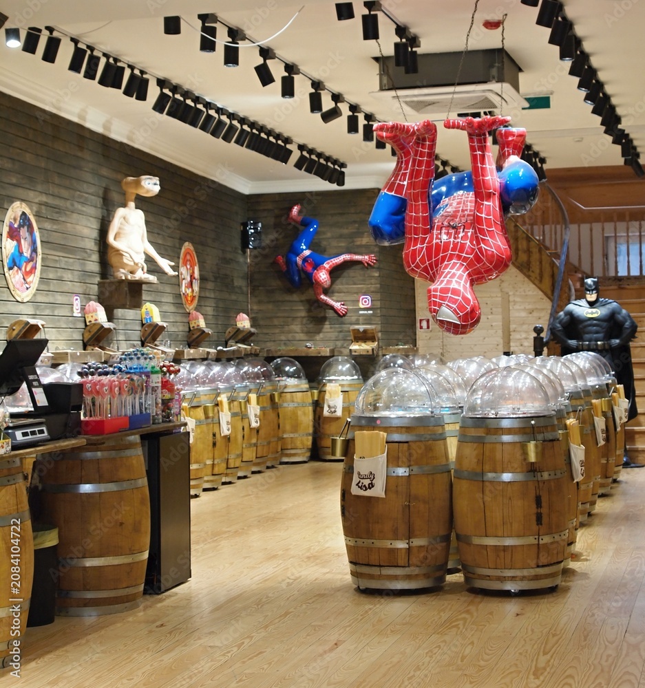 Obraz premium Spider-Man, E.T., Batman figures decorating a candy shop