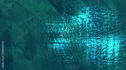 Animated abstract grunge background in turquoise tones. Looped texture with scratches, paint strokes and scuffs.