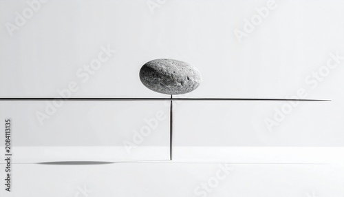 A delicate balance of a single stone precariously perched on a sharp point, symbolizing fragility and equilibrium. The minimalist composition evokes a sense of calm and contemplation.