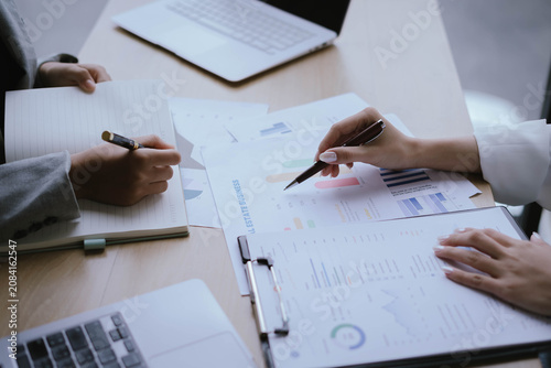 Business Professionals Reviewing Financial Reports and Performance Charts