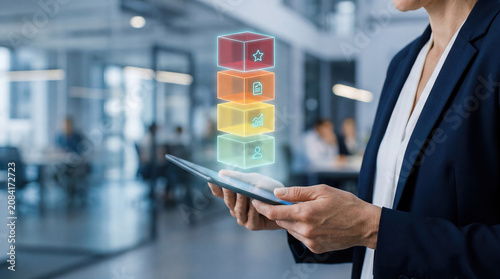 Hands holding a tablet with a holographic AI risk classification pyramid, EU AI Act compliance and regulatory risk tier concept in a modern office