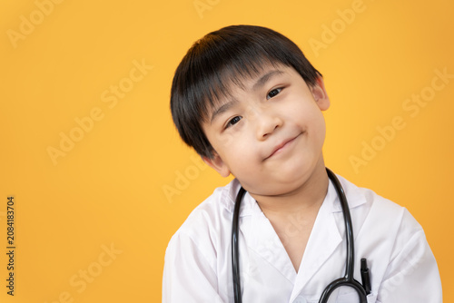 Tableau sur toile Young cute Asian boy playing doctor with favorite toys