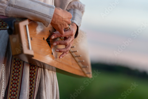 Obraz na plátně Traditional Latvian Kokle Player During Jāņi Midsummer Celebration