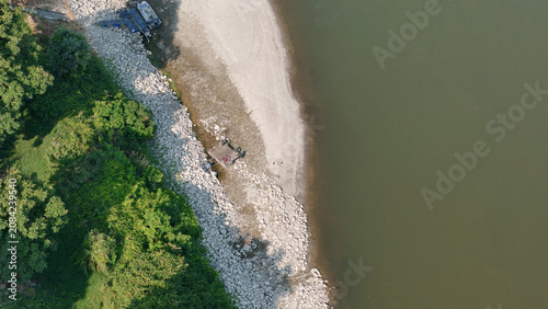 Canvastavla Po River's drastic water level drop revealing a vast dry riverbed and wide shore