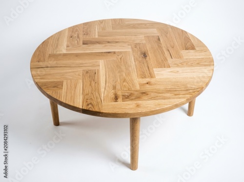 Round wooden coffee table with herringbone pattern isolated on white background