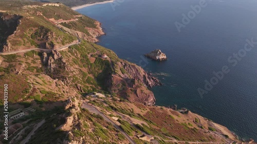 Aerial drone panorama of Scoglio il Morto near Nebida on the wild Sulcis Iglesiente coastline in south-west Sardinia, showcasing turquoise sea, dramatic limestone cliffs and scenic Mediterranean