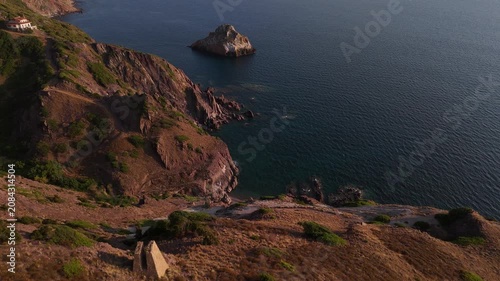Aerial drone panorama of Scoglio il Morto near Nebida on the wild Sulcis Iglesiente coastline in south-west Sardinia, showcasing turquoise sea, dramatic limestone cliffs and scenic Mediterranean