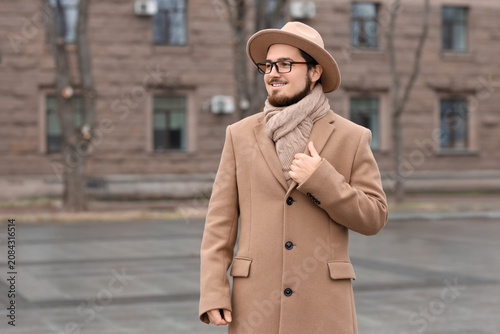 Stylish young man in coat w...