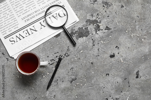Newspaper with magnifier, p...