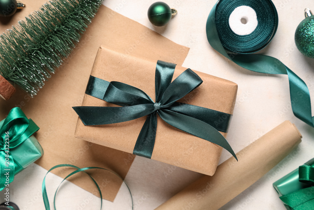 Fototapeta premium Christmas gift boxes with packing materials and decorations on white background