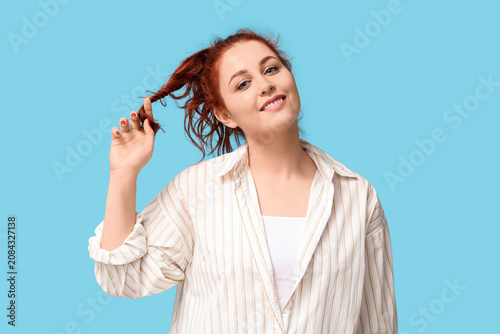 Smiling young redhead woman...