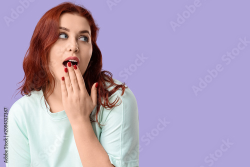 Surprised young redhead wom...