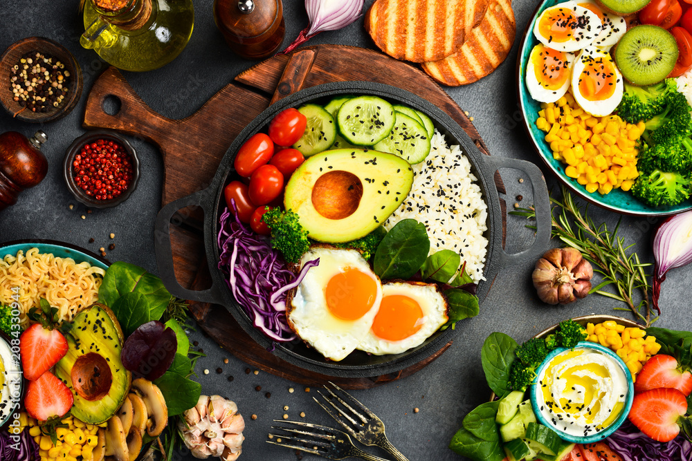Obraz premium Buddha bowl. Set of healthy and nutritious food in bowls. Top view. Dietary nutrition.