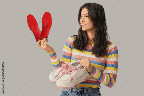 Young woman holding orthope...