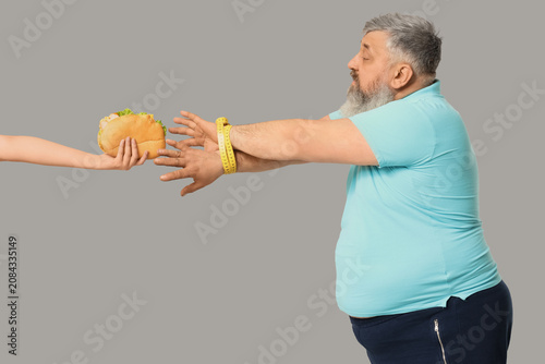 Overweight mature man hands...
