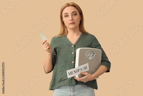 Mature woman holding paper ...
