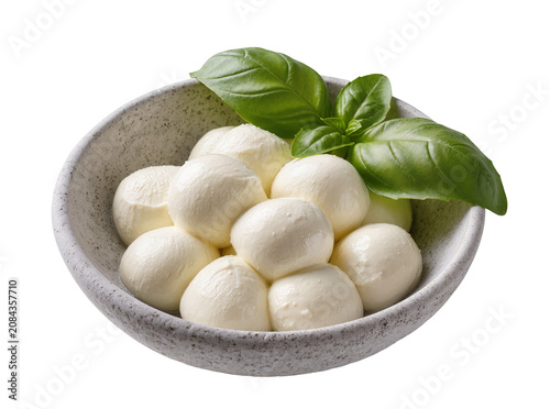 Isolated delicious fresh mozzarella cheese balls and vibrant green basil leaves in a rustic bowl.