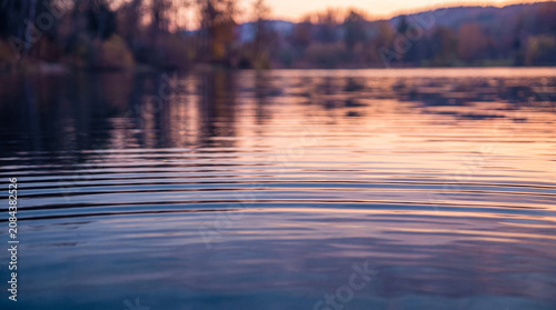 Photos Calm lake surface with ripples at sunset Water
